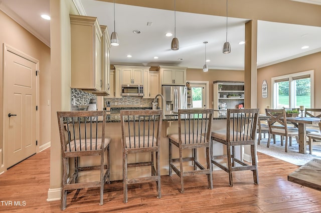133 Christopher Way, Blountville, TN 37617 - kitchen with cream cabinetry, stainless steel appliances, crown molding, backsplash, and a kitchen breakfast bar