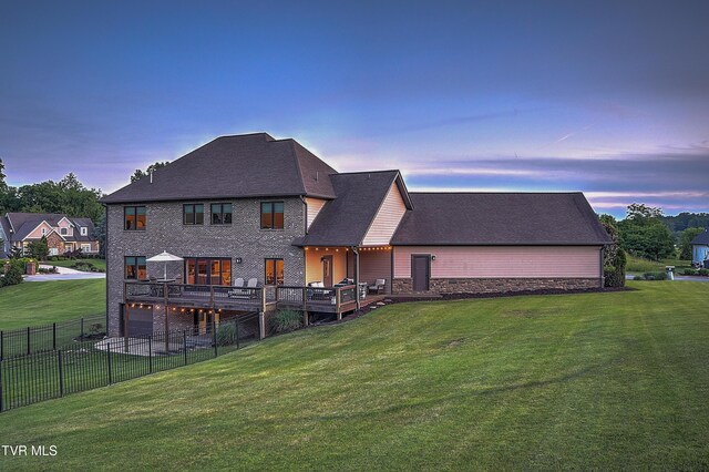 133 Christopher Way, Blountville, TN 37617 - back of property at dusk featuring a deck, stone siding, and a shingled roof