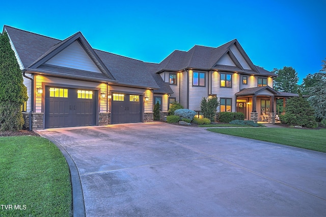 133 Christopher Way, Blountville, TN 37617 - view of front facade featuring driveway, a garage, stone siding, a front yard, and a shingled roof