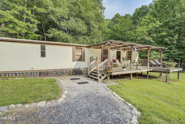 111 Jd Whitehead Rd, Roan Mountain, TN 37687 - manufactured / mobile home with a wooden deck, a front yard, and a view of trees