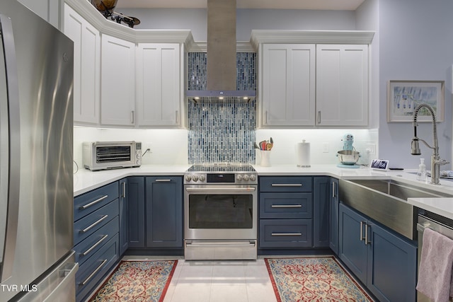 111 Jd Whitehead Rd, Roan Mountain, TN 37687 - kitchen featuring appliances with stainless steel finishes, wall chimney exhaust hood, white cabinets, and blue cabinets