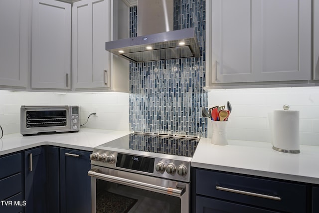 111 Jd Whitehead Rd, Roan Mountain, TN 37687 - kitchen featuring wall chimney exhaust hood, stainless steel range with electric stovetop, backsplash, and light countertops