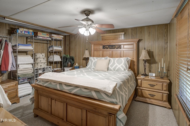 111 Jd Whitehead Rd, Roan Mountain, TN 37687 - bedroom with wood walls, light carpet, and ceiling fan