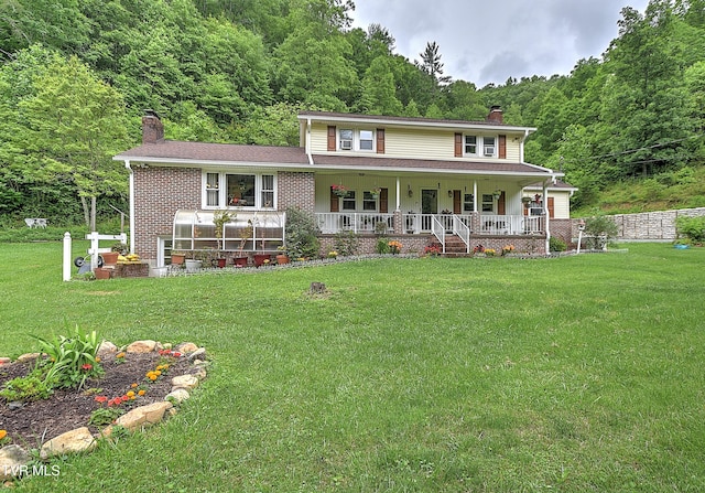 24483 Cave Creek Rd, Abingdon, VA 24211 - view of front of property featuring a chimney, a view of trees, a porch, and a front lawn