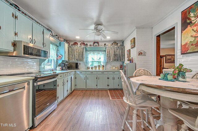 24483 Cave Creek Rd, Abingdon, VA 24211 - kitchen with stainless steel appliances, a ceiling fan, light wood-type flooring, backsplash, and light countertops