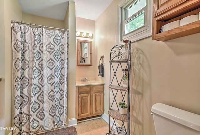 24483 Cave Creek Rd, Abingdon, VA 24211 - full bath with toilet, vanity, tile patterned flooring, a shower with shower curtain, and baseboards