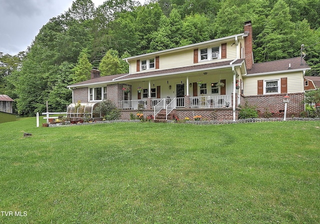 24483 Cave Creek Rd, Abingdon, VA 24211 - view of front facade with a chimney, a porch, a front yard, and a view of trees