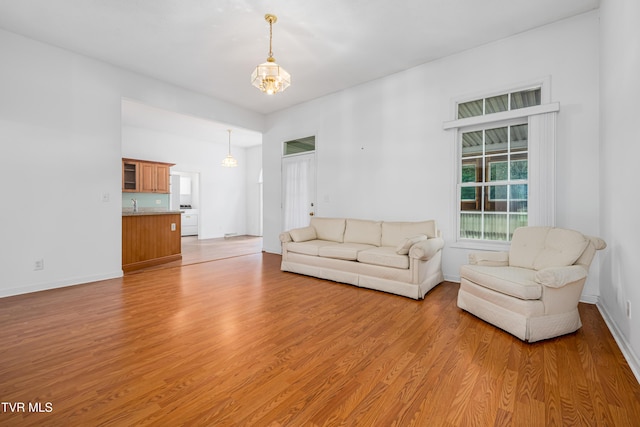 4006 Navaho Dr, Johnson City, TN 37604 - living room featuring light wood-type flooring, baseboards, and a chandelier