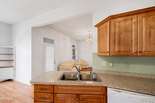 4006 Navaho Dr, Johnson City, TN 37604 - kitchen with a sink, white dishwasher, light wood-type flooring, a peninsula, and brown cabinets
