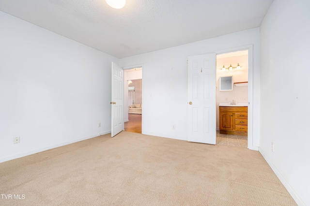 4006 Navaho Dr, Johnson City, TN 37604 - unfurnished bedroom with light carpet, baseboards, ensuite bath, and a sink