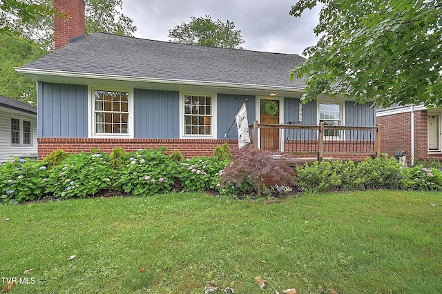 1449 Warpath Dr, Kingsport, TN 37664 - view of front of house with brick siding, a front yard, board and batten siding, and a shingled roof