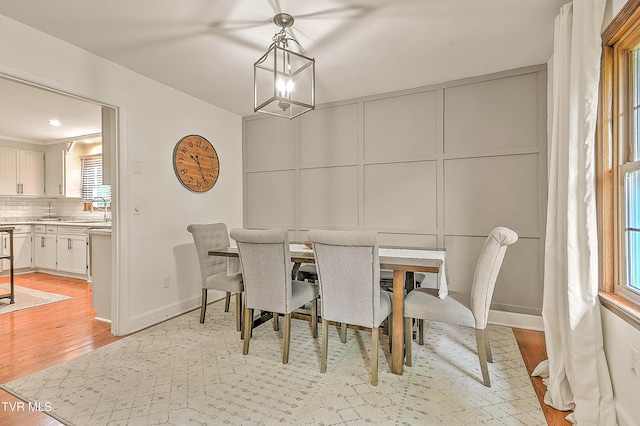 1449 Warpath Dr, Kingsport, TN 37664 - dining space with a decorative wall, light wood-type flooring, baseboards, and a chandelier