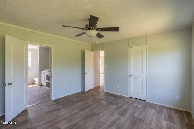 255 Piney Grove Rd, Greeneville, TN 37743 - unfurnished bedroom featuring dark wood-style floors, a textured ceiling, baseboards, a ceiling fan, and ornamental molding