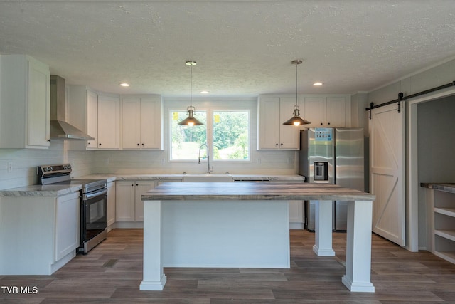 255 Piney Grove Rd, Greeneville, TN 37743 - kitchen featuring appliances with stainless steel finishes, wall chimney range hood, a sink, tasteful backsplash, and dark wood-style flooring