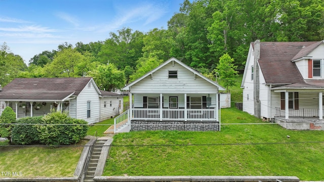 631 NE Meadow St, Coeburn, VA 24230 - view of front of home with covered porch and a front lawn
