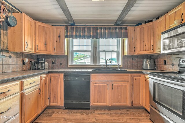 12350 Reedy Creek Rd, Bristol, VA 24202 - kitchen with appliances with stainless steel finishes, a sink, tasteful backsplash, wood finished floors, and beamed ceiling