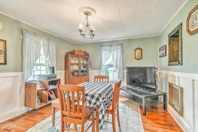 12350 Reedy Creek Rd, Bristol, VA 24202 - dining room with ornamental molding, a chandelier, a wainscoted wall, and wood finished floors