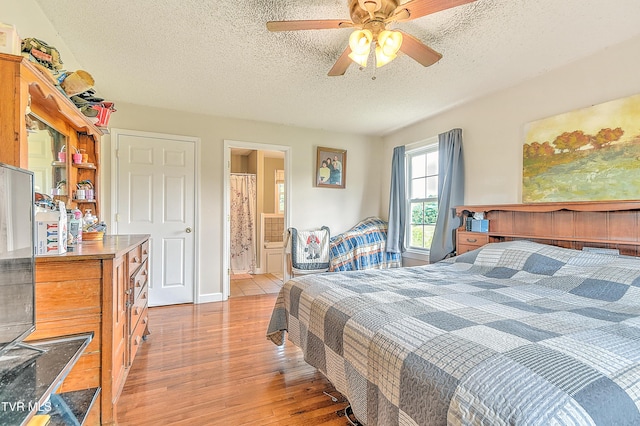 12350 Reedy Creek Rd, Bristol, VA 24202 - bedroom with light wood-style floors, a textured ceiling, a ceiling fan, and connected bathroom