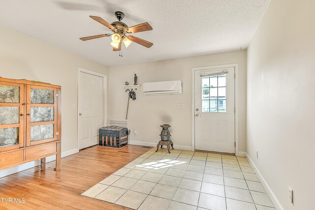 12350 Reedy Creek Rd, Bristol, VA 24202 - foyer featuring a wall unit AC, ceiling fan, light wood-style floors, and baseboards