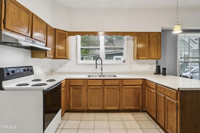 115 W Poplar St, Johnson City, TN 37604 - kitchen featuring white range with electric stovetop, under cabinet range hood, a sink, a peninsula, and light countertops