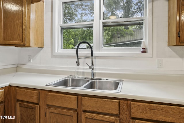 115 W Poplar St, Johnson City, TN 37604 - kitchen featuring a sink, brown cabinetry, and light countertops