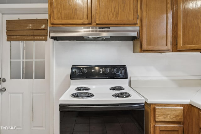 115 W Poplar St, Johnson City, TN 37604 - kitchen with range with electric stovetop, under cabinet range hood, tile patterned floors, light countertops, and brown cabinets