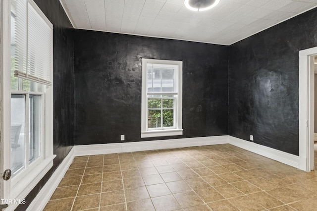 115 W Poplar St, Johnson City, TN 37604 - spare room featuring healthy amount of natural light, tile patterned floors, and baseboards