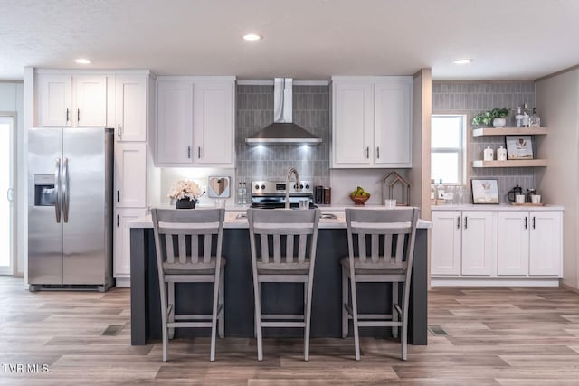 913 Henry Harr Rd, Blountville, TN 37617 - kitchen featuring stainless steel appliances, wall chimney exhaust hood, light countertops, decorative backsplash, and a sink