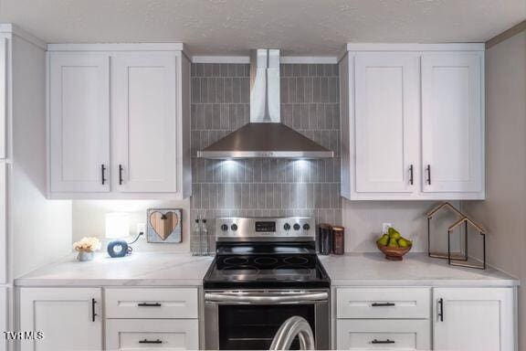913 Henry Harr Rd, Blountville, TN 37617 - kitchen with wall chimney exhaust hood, stainless steel electric range oven, white cabinets, light countertops, and backsplash