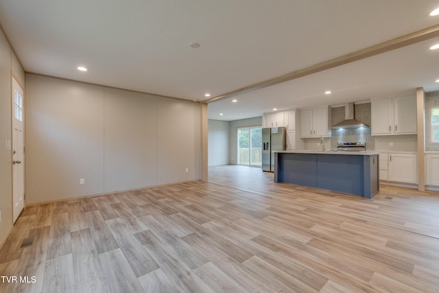 913 Henry Harr Rd, Blountville, TN 37617 - kitchen with stainless steel fridge with ice dispenser, wall chimney range hood, white cabinets, recessed lighting, and light wood finished floors