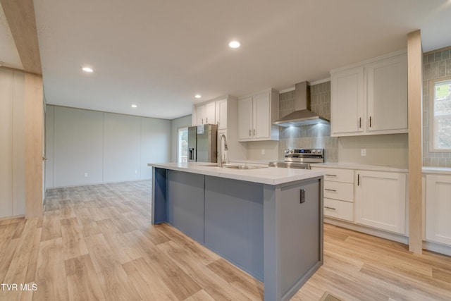 913 Henry Harr Rd, Blountville, TN 37617 - kitchen with wall chimney exhaust hood, a sink, light countertops, stainless steel appliances, and white cabinetry