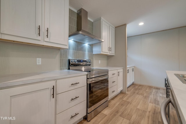 913 Henry Harr Rd, Blountville, TN 37617 - kitchen with wall chimney exhaust hood, stainless steel range with electric stovetop, backsplash, light countertops, and white cabinetry