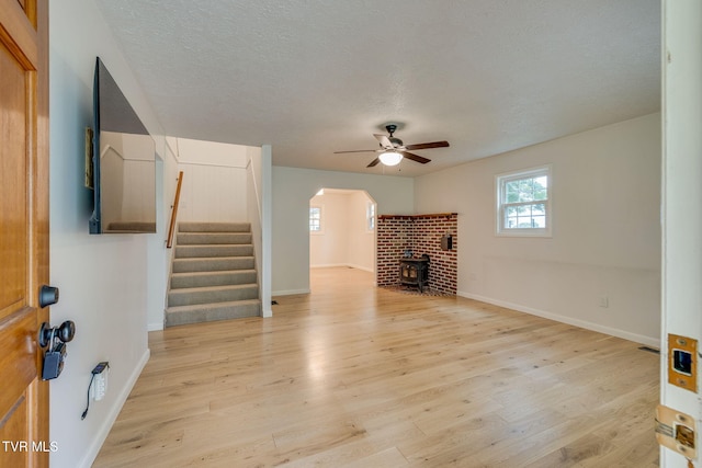 319 Woodland Rd, Jonesborough, TN 37659 - unfurnished living room featuring ceiling fan, arched walkways, stairway, light wood-type flooring, and a textured ceiling
