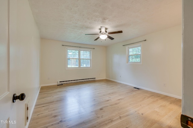 319 Woodland Rd, Jonesborough, TN 37659 - unfurnished room featuring a baseboard heating unit, a textured ceiling, ceiling fan, baseboards, and light wood-style floors