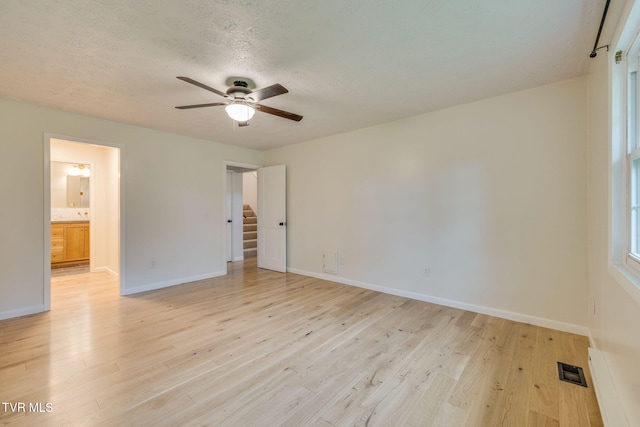319 Woodland Rd, Jonesborough, TN 37659 - empty room with ceiling fan, baseboards, light wood-style floors, and a textured ceiling