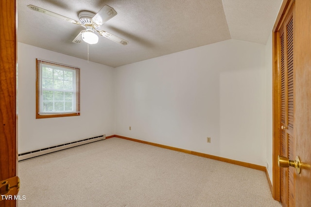 319 Woodland Rd, Jonesborough, TN 37659 - unfurnished bedroom with a baseboard radiator, light carpet, a closet, lofted ceiling, and a textured ceiling