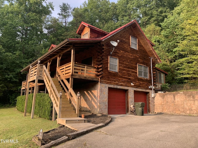 209 Brystone Dr, Gray, TN 37615 - view of side of property featuring log exterior, a garage, driveway, stairway, and stone siding