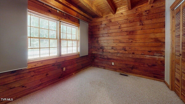 209 Brystone Dr, Gray, TN 37615 - carpeted empty room with wood walls and wooden ceiling with exposed beams