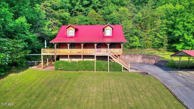 209 Brystone Dr, Gray, TN 37615 - log-style house featuring a porch, metal roof, a wooded view, and stairway