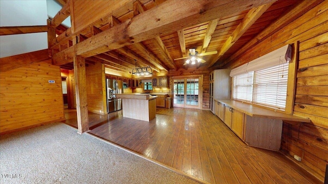 209 Brystone Dr, Gray, TN 37615 - kitchen featuring wood walls, a kitchen island, a ceiling fan, light wood-style floors, and stainless steel fridge