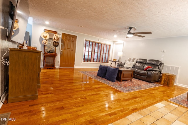 9266 Forest Rd, Coeburn, VA 24230 - living room with a ceiling fan, wood finished floors, a textured ceiling, and baseboards