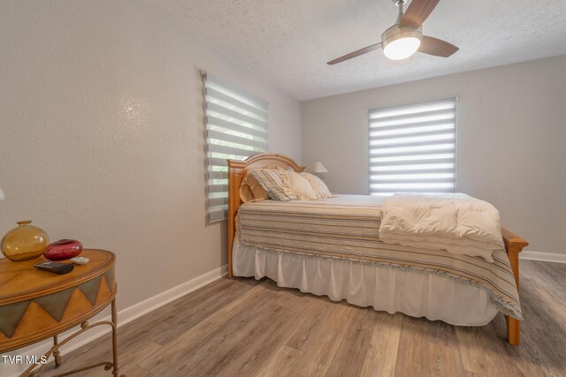 9266 Forest Rd, Coeburn, VA 24230 - bedroom with baseboards, a textured ceiling, wood finished floors, and ceiling fan