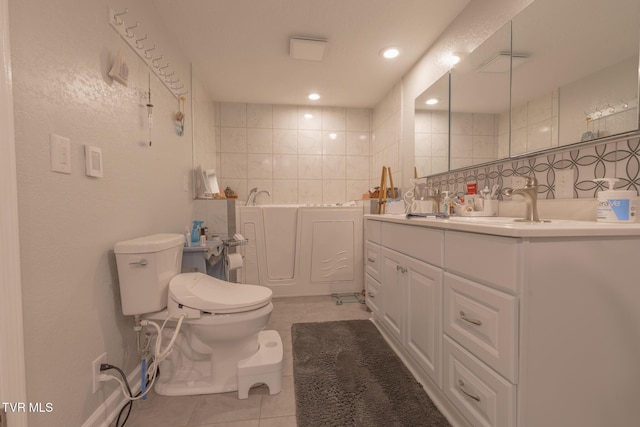 9266 Forest Rd, Coeburn, VA 24230 - bathroom featuring tile patterned floors, toilet, double vanity, tile walls, and a garden tub