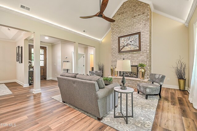 302 Charlton Ct, Bluff City, TN 37618 - living area featuring wood finished floors, ceiling fan, a brick fireplace, baseboards, and high vaulted ceiling
