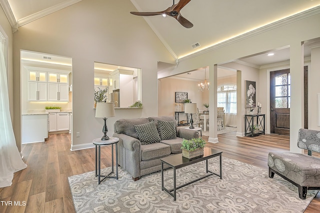 302 Charlton Ct, Bluff City, TN 37618 - living area with a ceiling fan, baseboards, wood finished floors, crown molding, and high vaulted ceiling