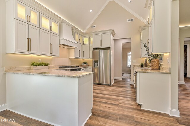 302 Charlton Ct, Bluff City, TN 37618 - kitchen with high quality fridge, custom range hood, a peninsula, light stone countertops, and a sink