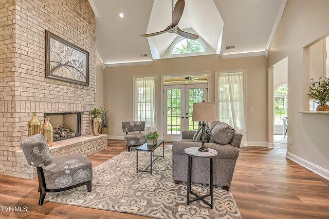 302 Charlton Ct, Bluff City, TN 37618 - living area with wood finished floors, a fireplace, ornamental molding, baseboards, and lofted ceiling