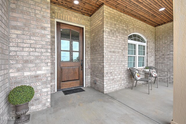 302 Charlton Ct, Bluff City, TN 37618 - view of exterior entry with covered porch and brick siding