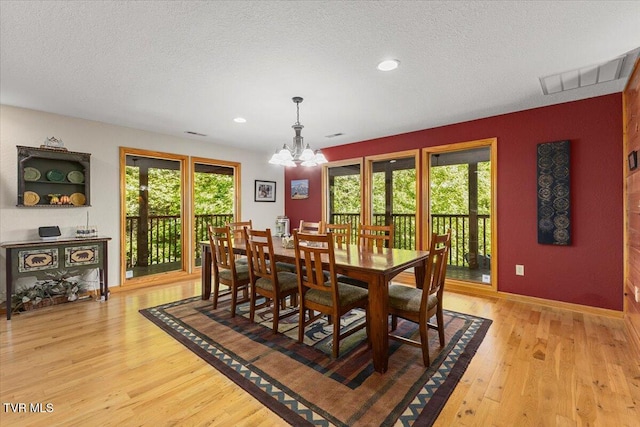 2213 Woodcock Trl, Sevierville, TN 37876 - dining room with light wood finished floors, a chandelier, baseboards, recessed lighting, and a textured ceiling