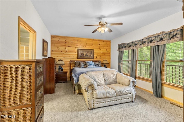 2213 Woodcock Trl, Sevierville, TN 37876 - bedroom with light carpet, wooden walls, and ceiling fan
